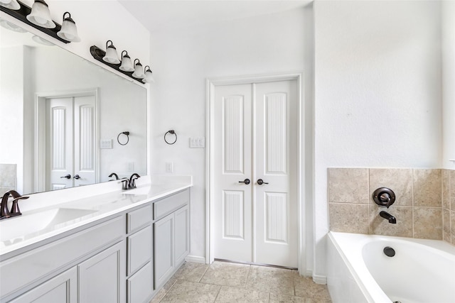 bathroom with a garden tub, a sink, and double vanity