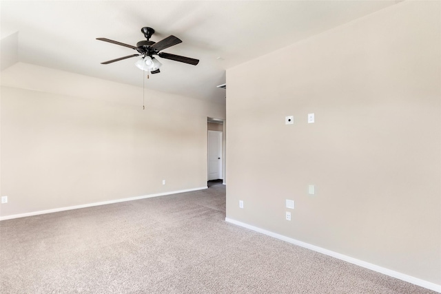 carpeted empty room with ceiling fan and baseboards