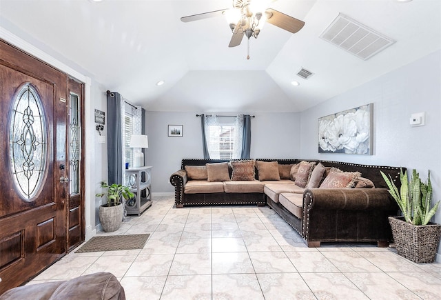 living area with lofted ceiling, ceiling fan, visible vents, and baseboards