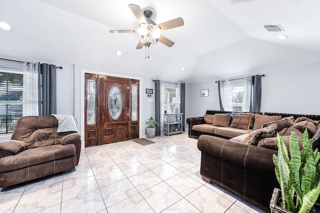 living area featuring lofted ceiling, ceiling fan, visible vents, and recessed lighting