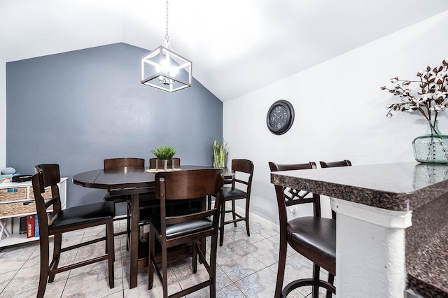 dining room with lofted ceiling, light tile patterned flooring, baseboards, and an inviting chandelier