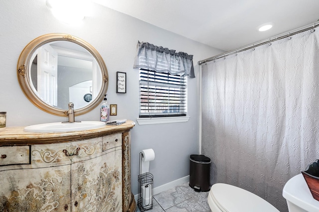 full bathroom with baseboards, vanity, toilet, and tile patterned floors