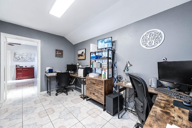 home office with lofted ceiling, baseboards, and light tile patterned floors