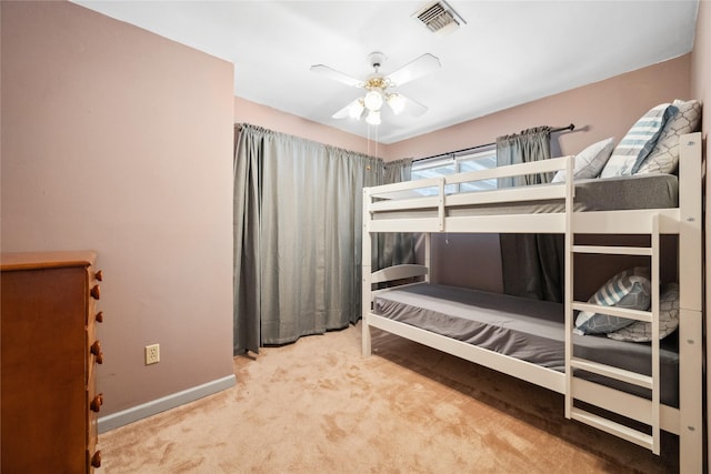 unfurnished bedroom featuring carpet floors, baseboards, a ceiling fan, and visible vents