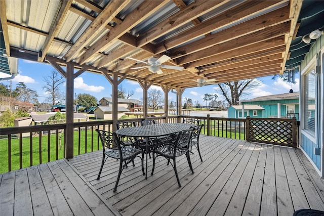 deck with a water view, a yard, a residential view, and outdoor dining space