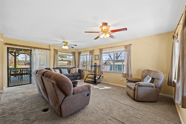 living room featuring carpet floors, a ceiling fan, and baseboards