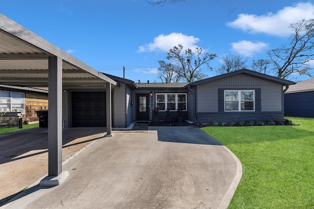 view of front of property featuring a front lawn, driveway, and an attached garage