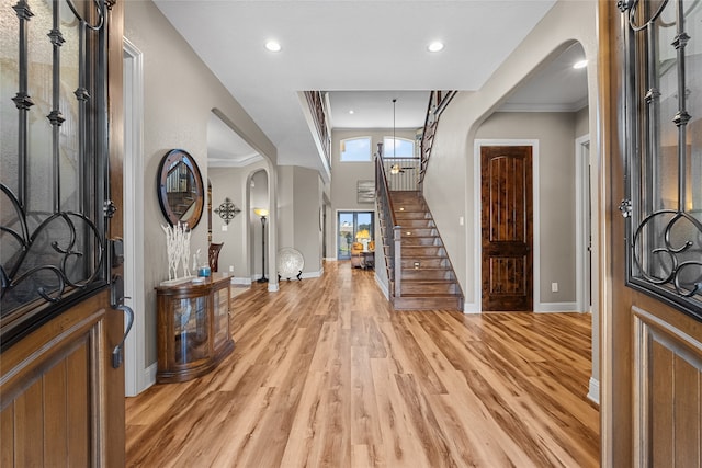 entrance foyer with recessed lighting, stairway, light wood-type flooring, and baseboards