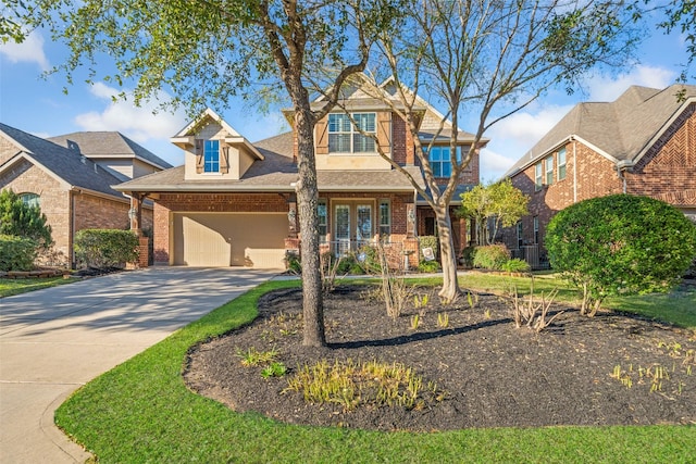 view of front of house featuring driveway, an attached garage, and brick siding