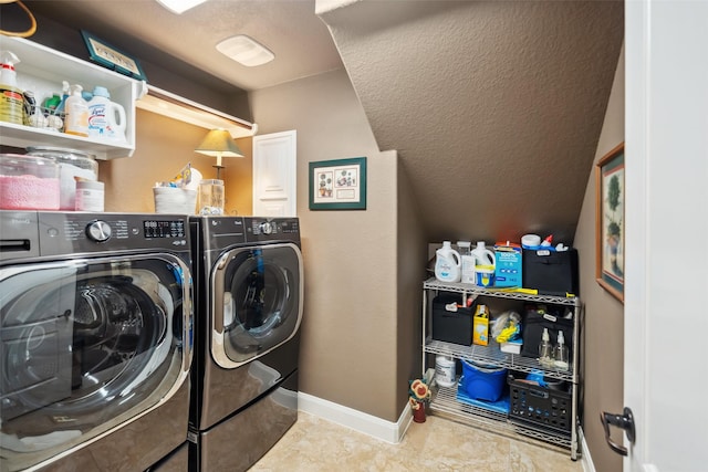 laundry room featuring laundry area, independent washer and dryer, a textured ceiling, and baseboards