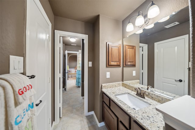 bathroom featuring visible vents, vanity, and baseboards