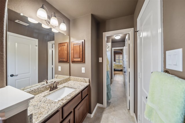 bathroom with visible vents, vanity, and baseboards