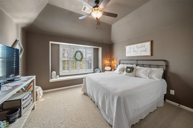 carpeted bedroom with ceiling fan, visible vents, baseboards, and vaulted ceiling