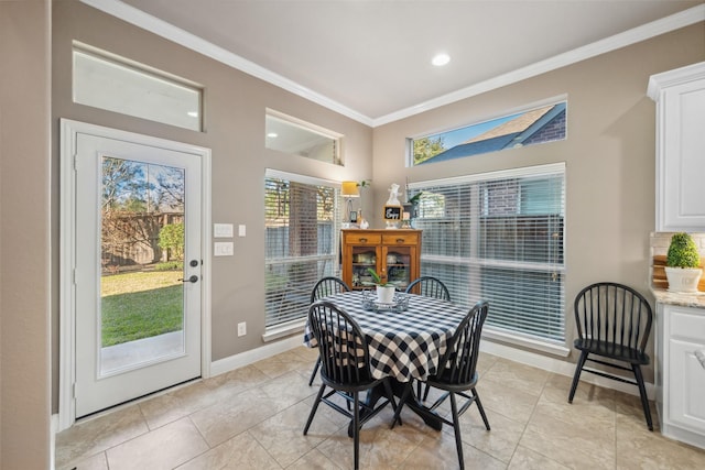 dining room with baseboards, ornamental molding, and recessed lighting