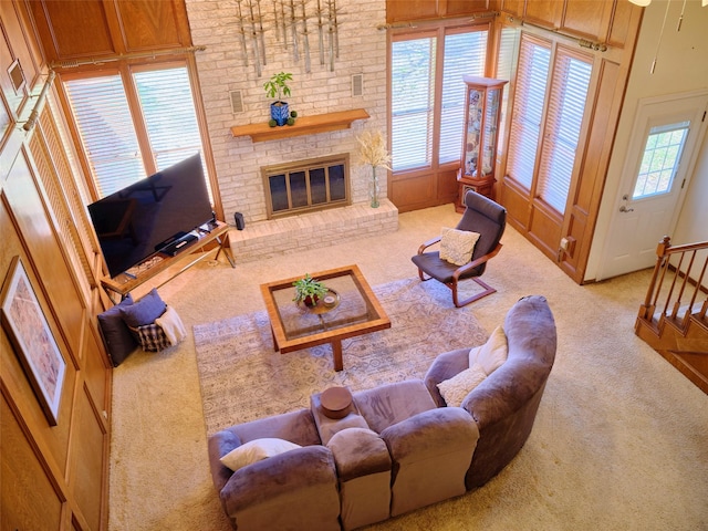 living area featuring a fireplace and carpet flooring