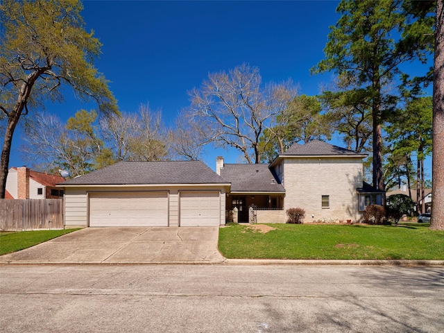 view of front of property with a front lawn, driveway, fence, a garage, and a chimney