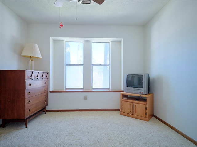 bedroom featuring ceiling fan, baseboards, carpet floors, and a textured ceiling