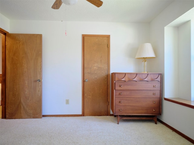 unfurnished bedroom featuring ceiling fan, baseboards, and carpet