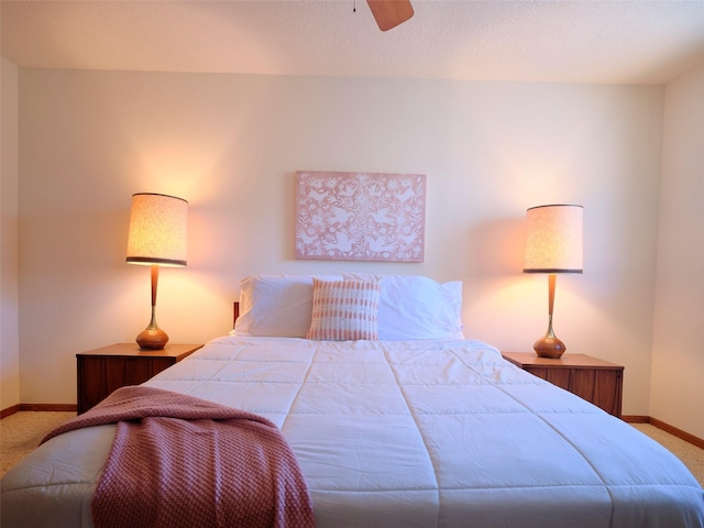 bedroom featuring a ceiling fan, carpet, and baseboards