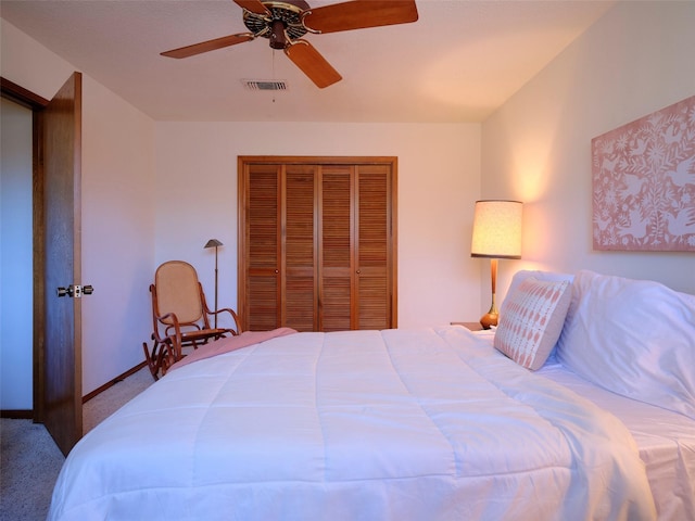 bedroom with carpet, baseboards, visible vents, ceiling fan, and a closet