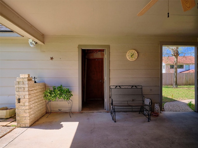 property entrance with a patio area and fence