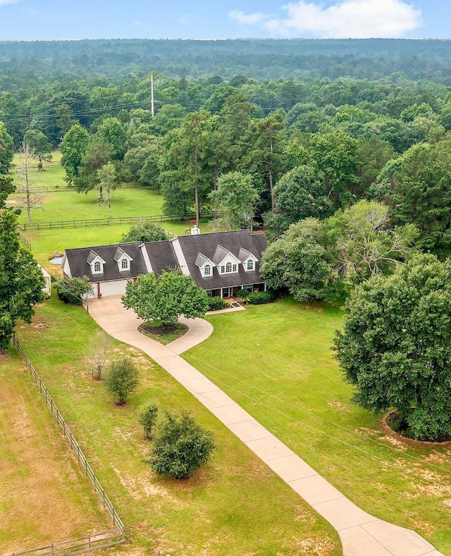 birds eye view of property featuring a forest view