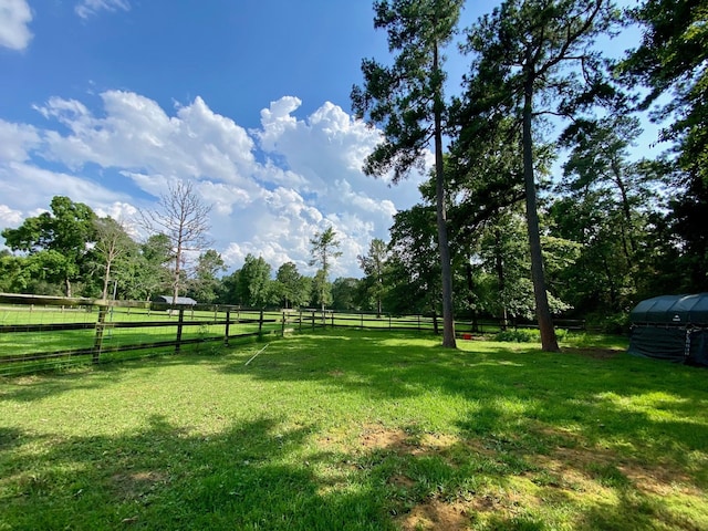 view of yard featuring a rural view and fence