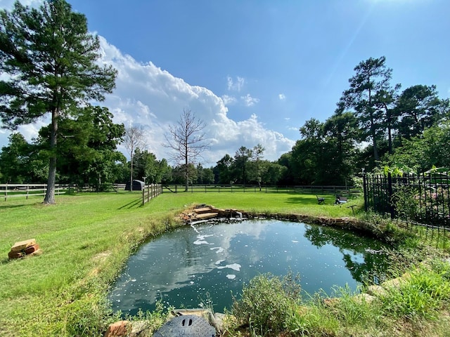 property view of water featuring fence