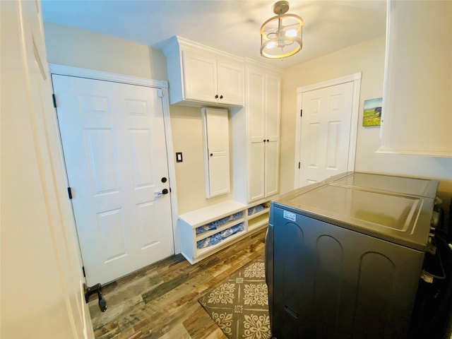 mudroom with separate washer and dryer and dark wood-style flooring