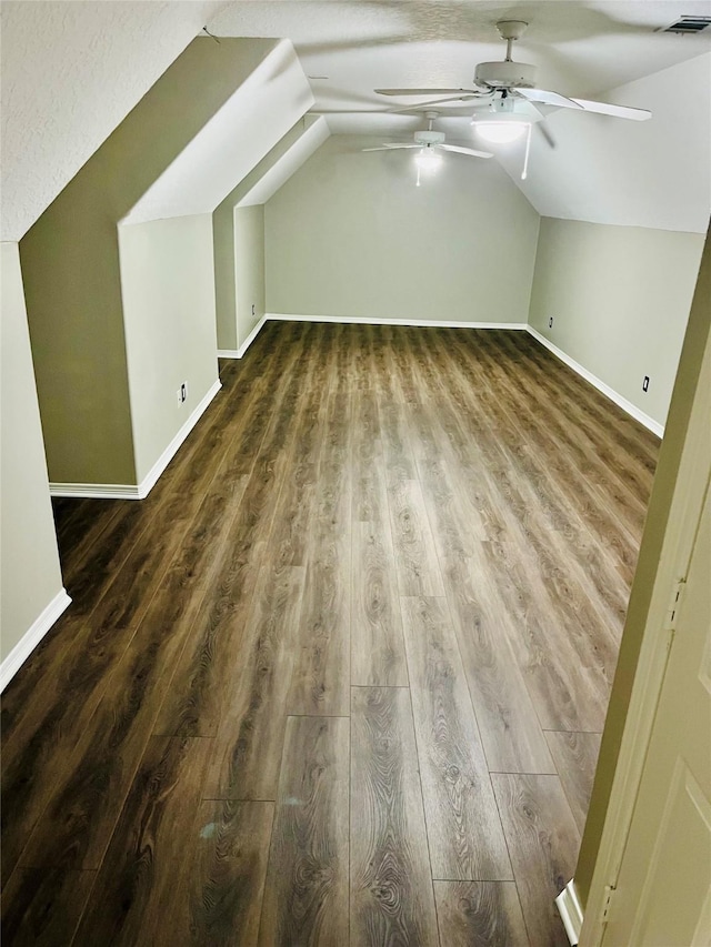 bonus room featuring dark wood-style floors, visible vents, vaulted ceiling, and a ceiling fan