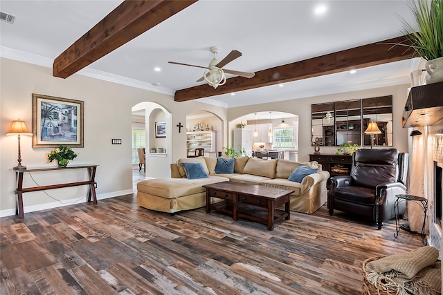 living area featuring dark wood-style floors, arched walkways, ceiling fan, beamed ceiling, and baseboards