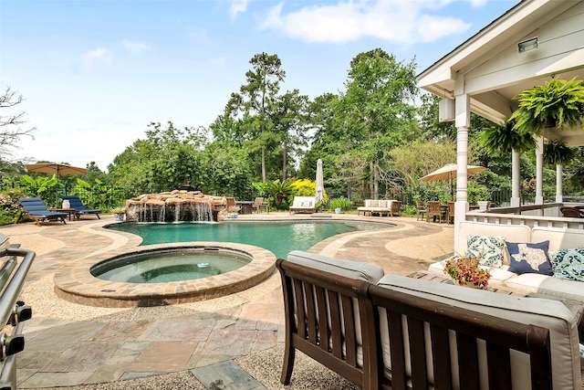 pool featuring an in ground hot tub, a patio area, and fence