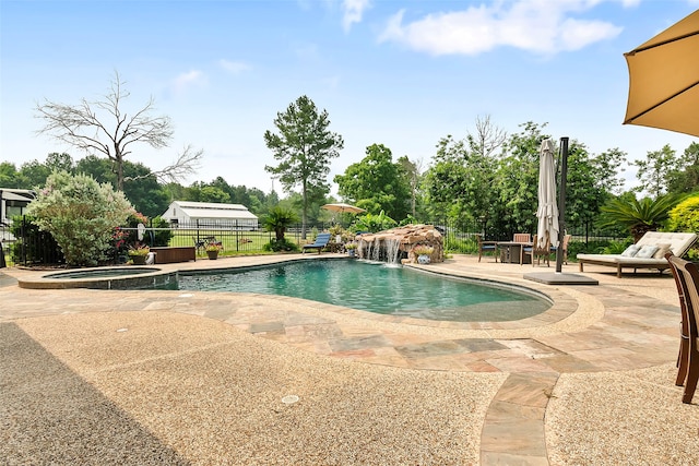 view of swimming pool with a patio area, a fenced backyard, and a pool with connected hot tub