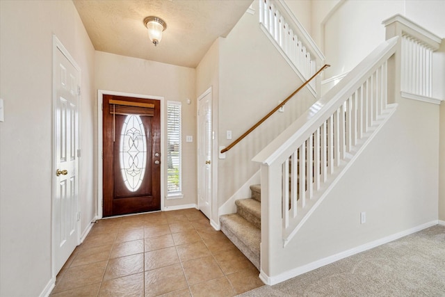 entrance foyer with baseboards and light tile patterned flooring