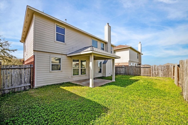 back of property with a yard, a fenced backyard, a patio, and brick siding