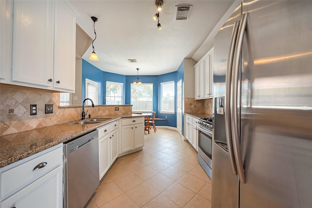 kitchen with white cabinets, visible vents, stainless steel appliances, and a sink