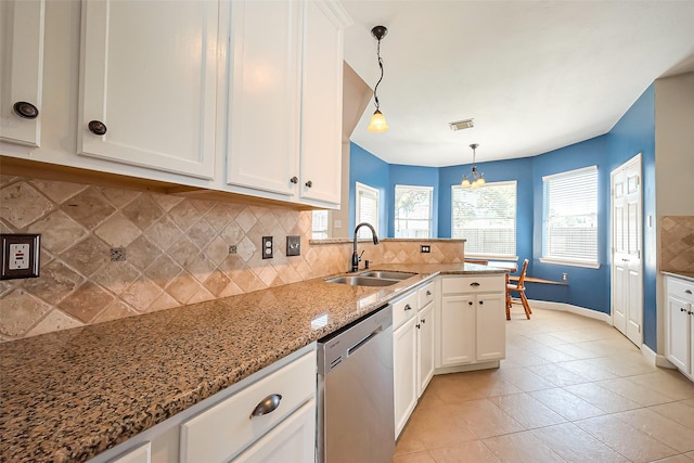 kitchen with tasteful backsplash, visible vents, stainless steel dishwasher, white cabinetry, and a sink