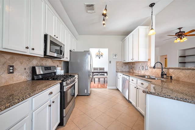 kitchen featuring stainless steel appliances, a sink, visible vents, and white cabinetry