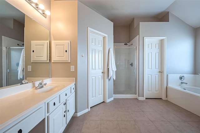 bathroom featuring a garden tub, a stall shower, vanity, baseboards, and tile patterned floors