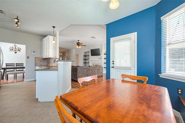 dining space featuring visible vents, ceiling fan, baseboards, and light tile patterned floors