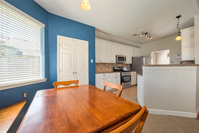 dining area featuring light tile patterned flooring and a wealth of natural light