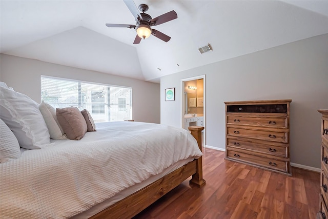 bedroom featuring baseboards, visible vents, vaulted ceiling, and wood finished floors