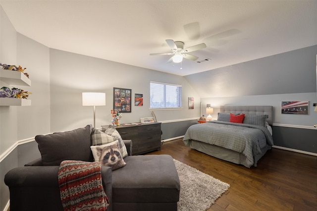 bedroom with lofted ceiling, wood finished floors, visible vents, baseboards, and a ceiling fan