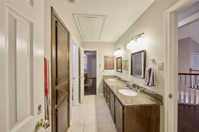 full bathroom featuring double vanity, a sink, ensuite bathroom, and tile patterned floors