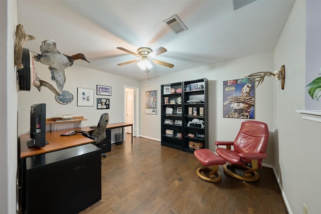 office space with visible vents, ceiling fan, a textured ceiling, wood finished floors, and baseboards