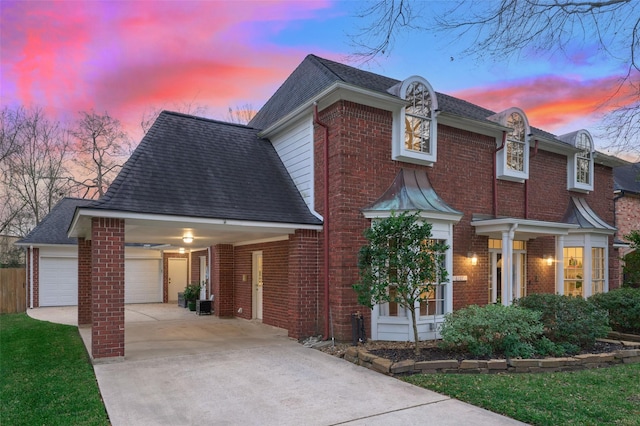 view of front facade featuring concrete driveway, brick siding, roof with shingles, and an attached garage