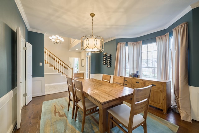 dining area with a wainscoted wall, ornamental molding, dark wood finished floors, and a wealth of natural light