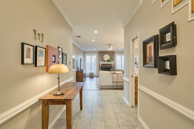 hall with recessed lighting, crown molding, baseboards, and light tile patterned floors