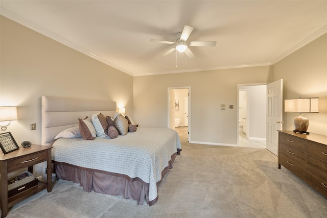 bedroom featuring crown molding, light colored carpet, ensuite bathroom, ceiling fan, and baseboards