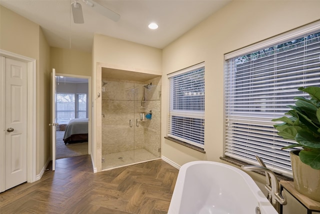 bathroom featuring baseboards, connected bathroom, a freestanding tub, a shower stall, and recessed lighting